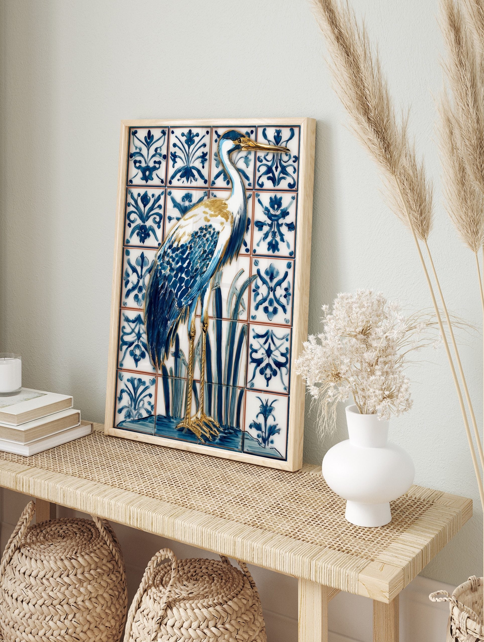 Blue and white heron bird illustration on ornate patterned tiles, with gold beak and legs, in an alternate framed mockup