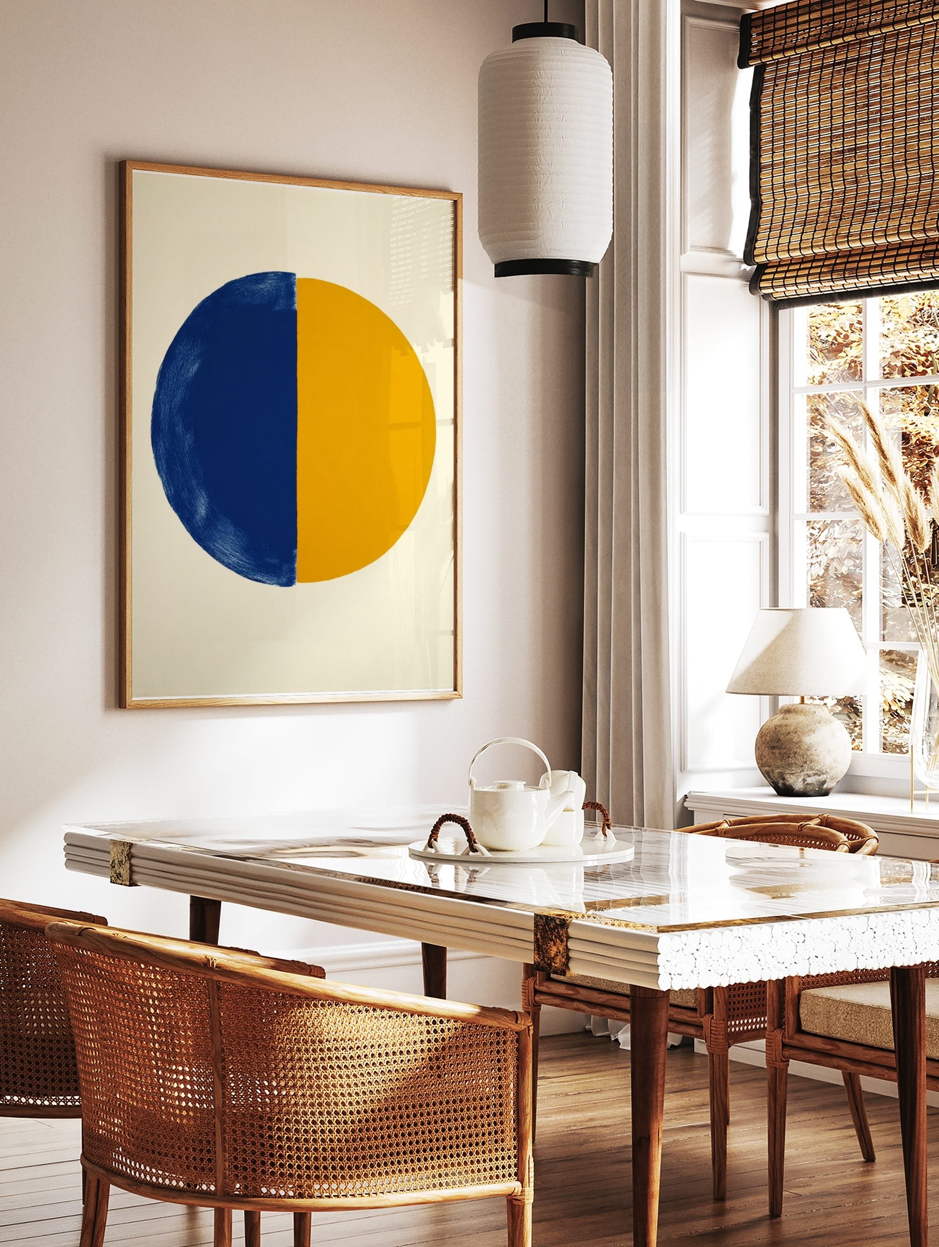 Abstract art print of a large circle divided vertically into a textured blue half and a smooth, in a styled room mockup