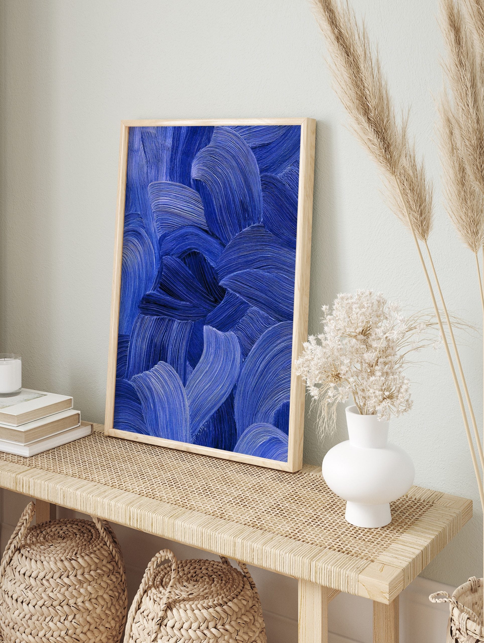 Close-up of blue abstract art with textured, flowing brushstrokes in indigo and cobalt tones, in an alternate framed mockup