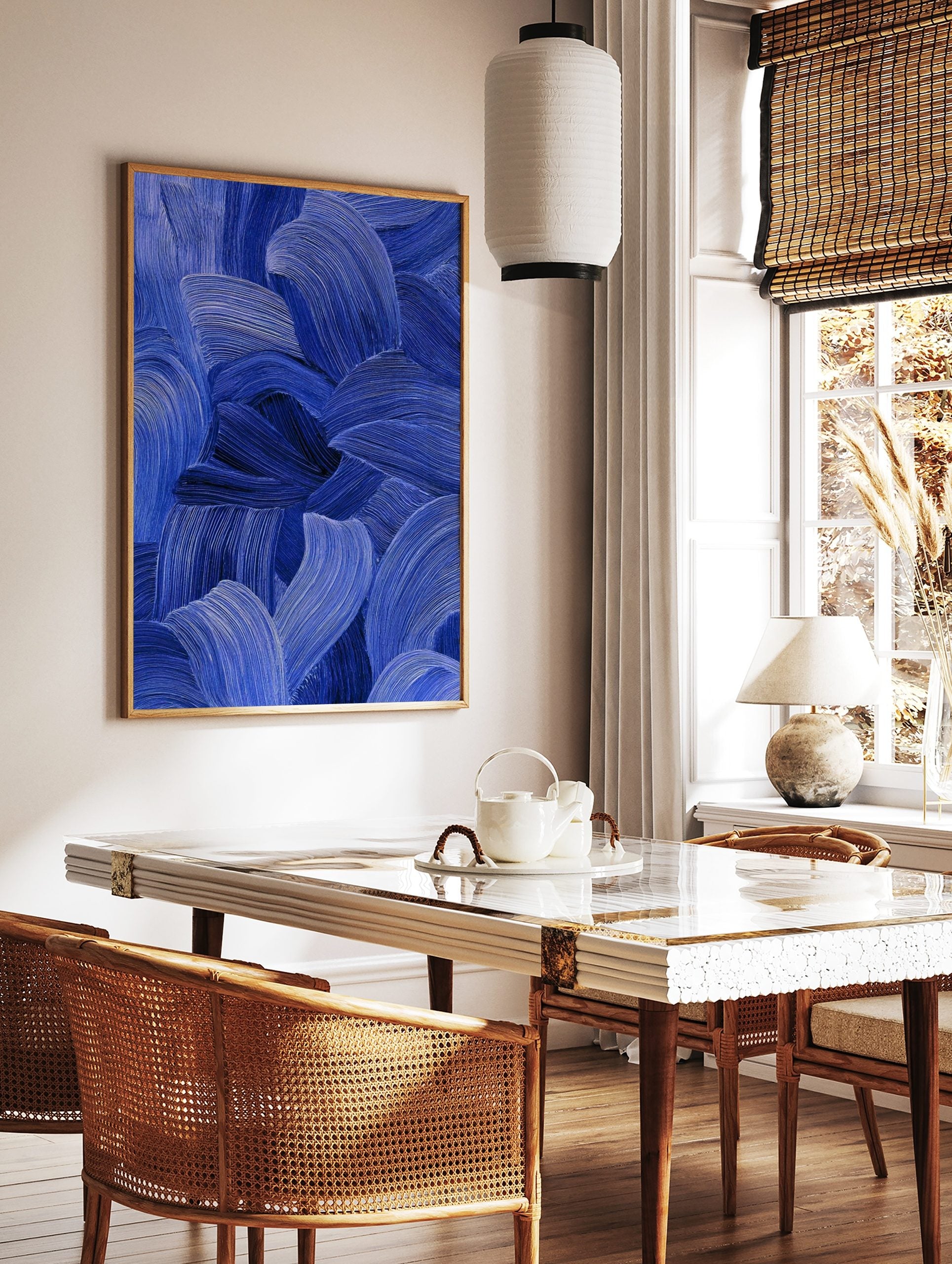 Close-up of blue abstract art with textured, flowing brushstrokes in indigo and cobalt tones, in a styled room mockup
