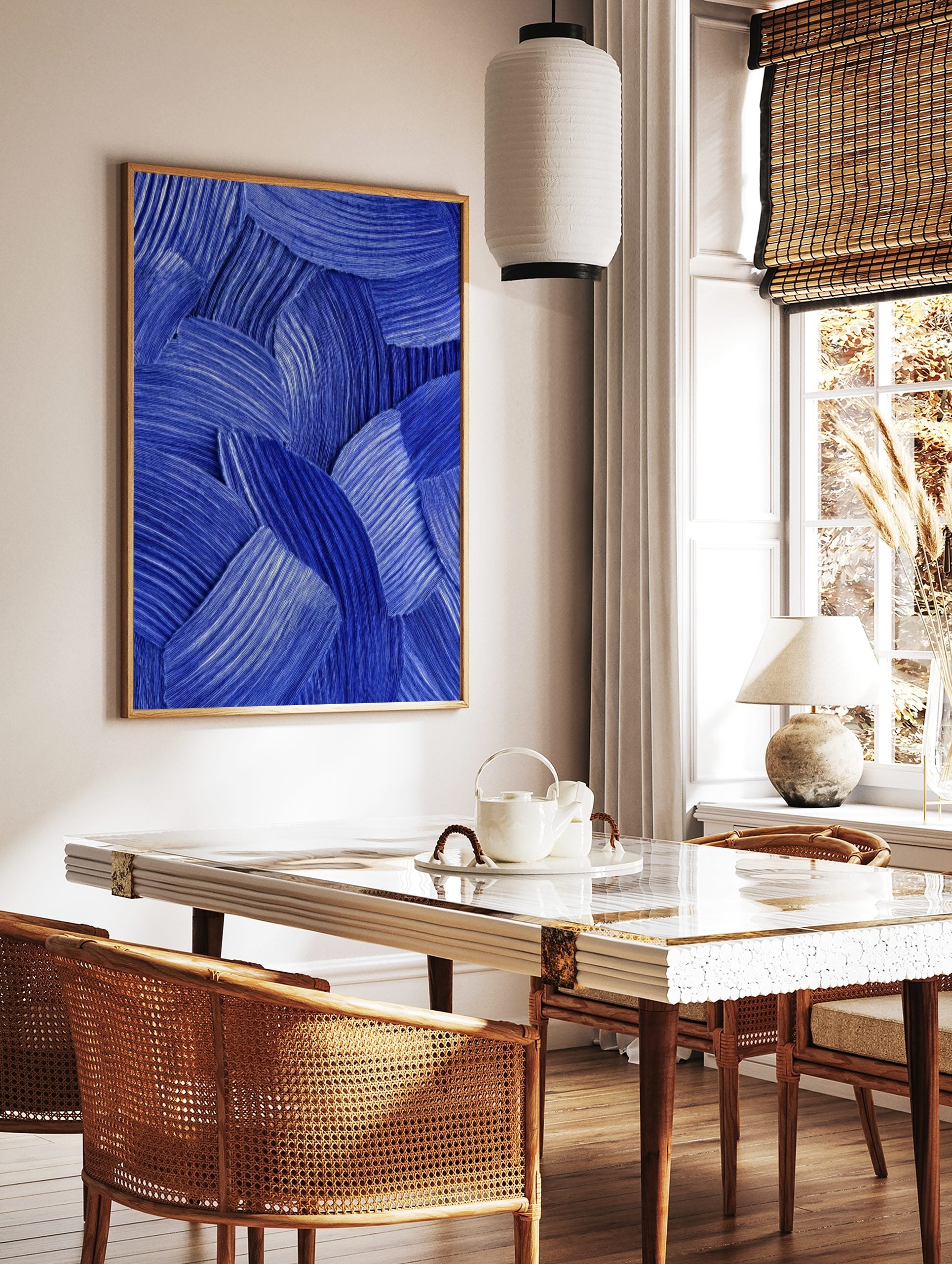 Blue abstract wall art with textured, overlapping curved brushstrokes and fine parallel lines, in a styled room mockup