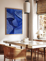 Abstract blue wall art with flowing, textured wave-like lines and layered forms, creating depth and, in a styled room mockup