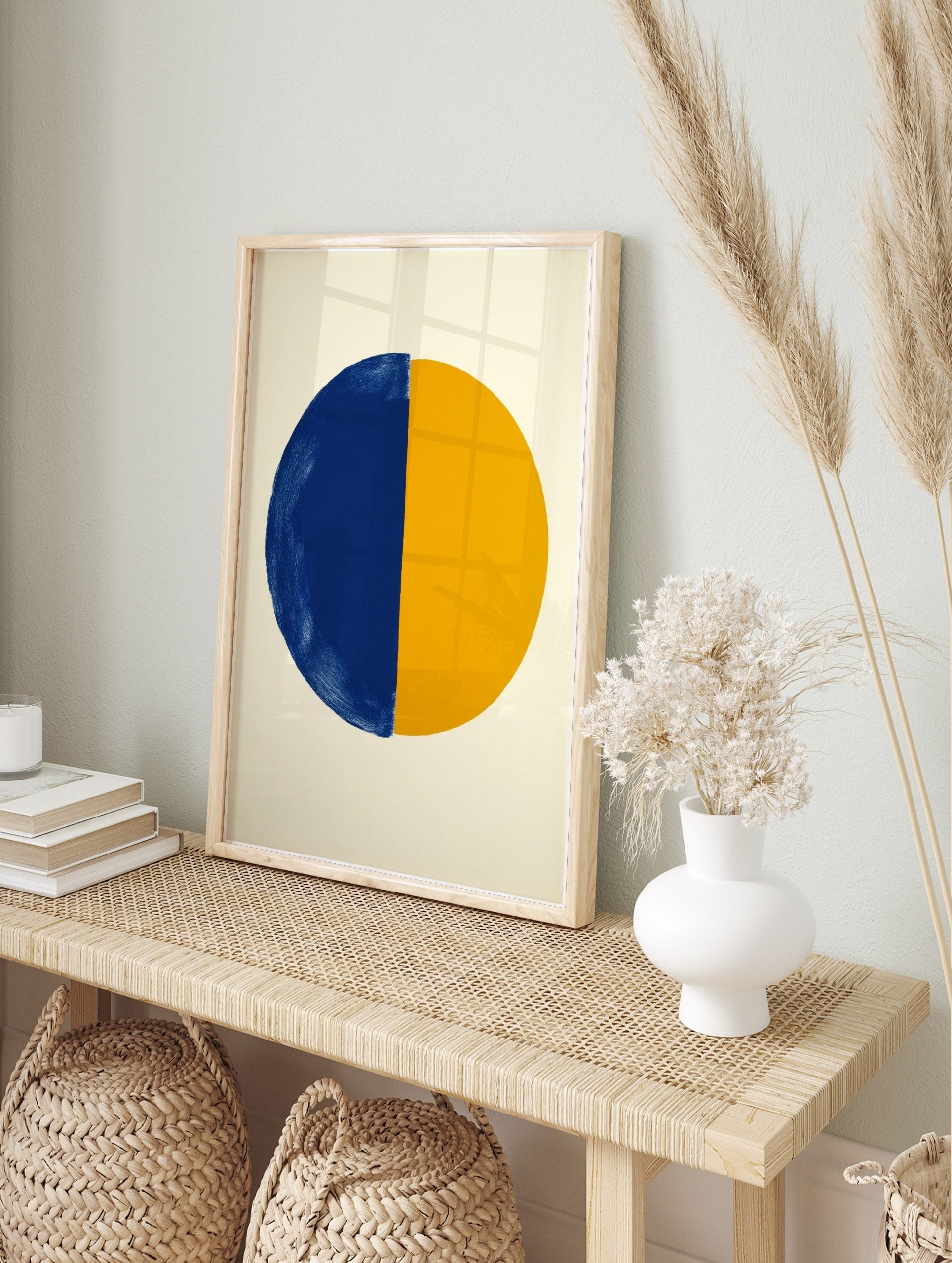 Abstract art print with a large circle split vertically into a textured blue half and a, in an alternate framed mockup
