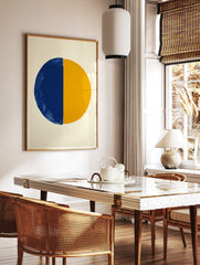 Abstract art print with a large circle split vertically into a textured blue half and a smooth, in a styled room mockup