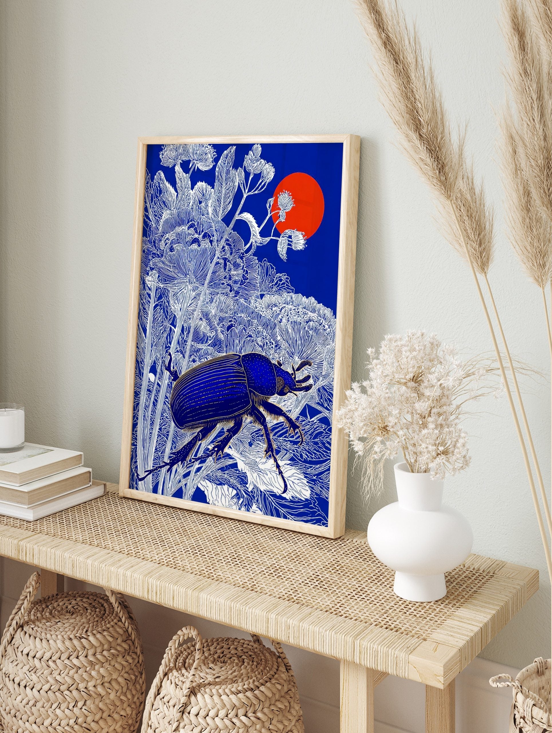 Blue beetle with golden details among white botanical line art, deep blue background, red sun, in an alternate framed mockup