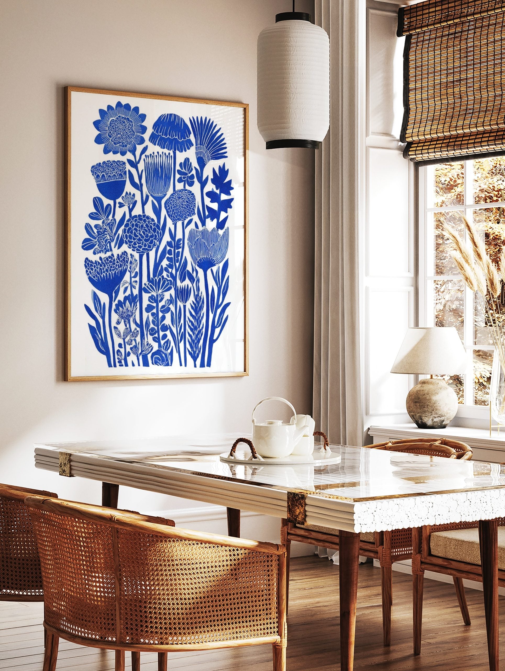 Blue botanical flower illustration art print with dense stylised floral forms on white background, in a styled room mockup