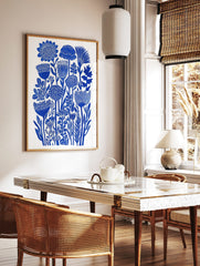 Blue botanical flower illustration art print with dense stylised floral forms on white background, in a styled room mockup