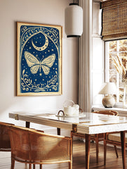 Illustrative blue and white butterfly with crescent moon, stars, and ornate botanical border art, in a styled room mockup