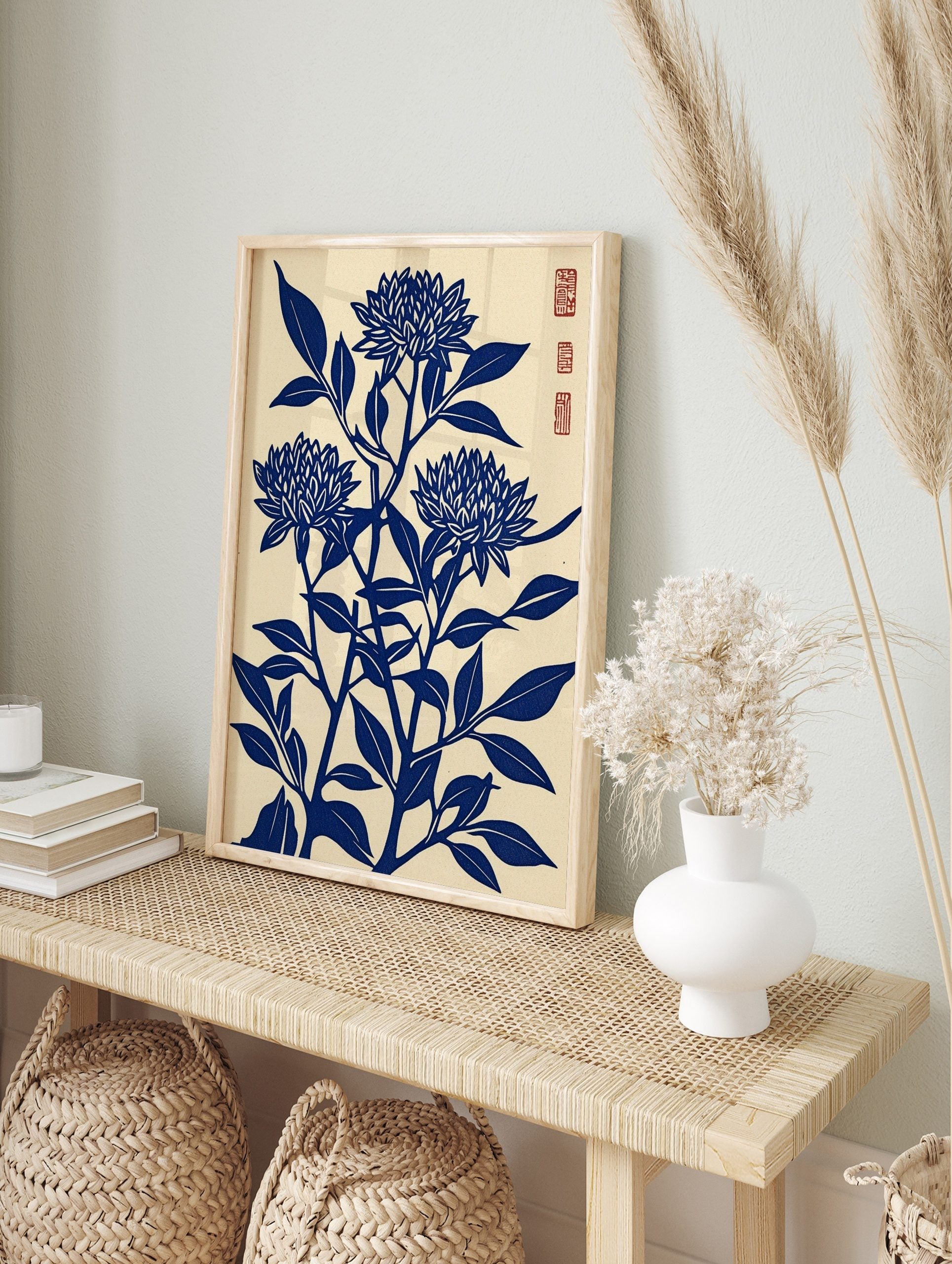 Blue chrysanthemum flower woodblock art print with leaves on a cream background, portrait, in an alternate framed mockup