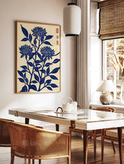 Blue chrysanthemum flower woodblock art print with leaves on a cream background, portrait, in a styled room mockup