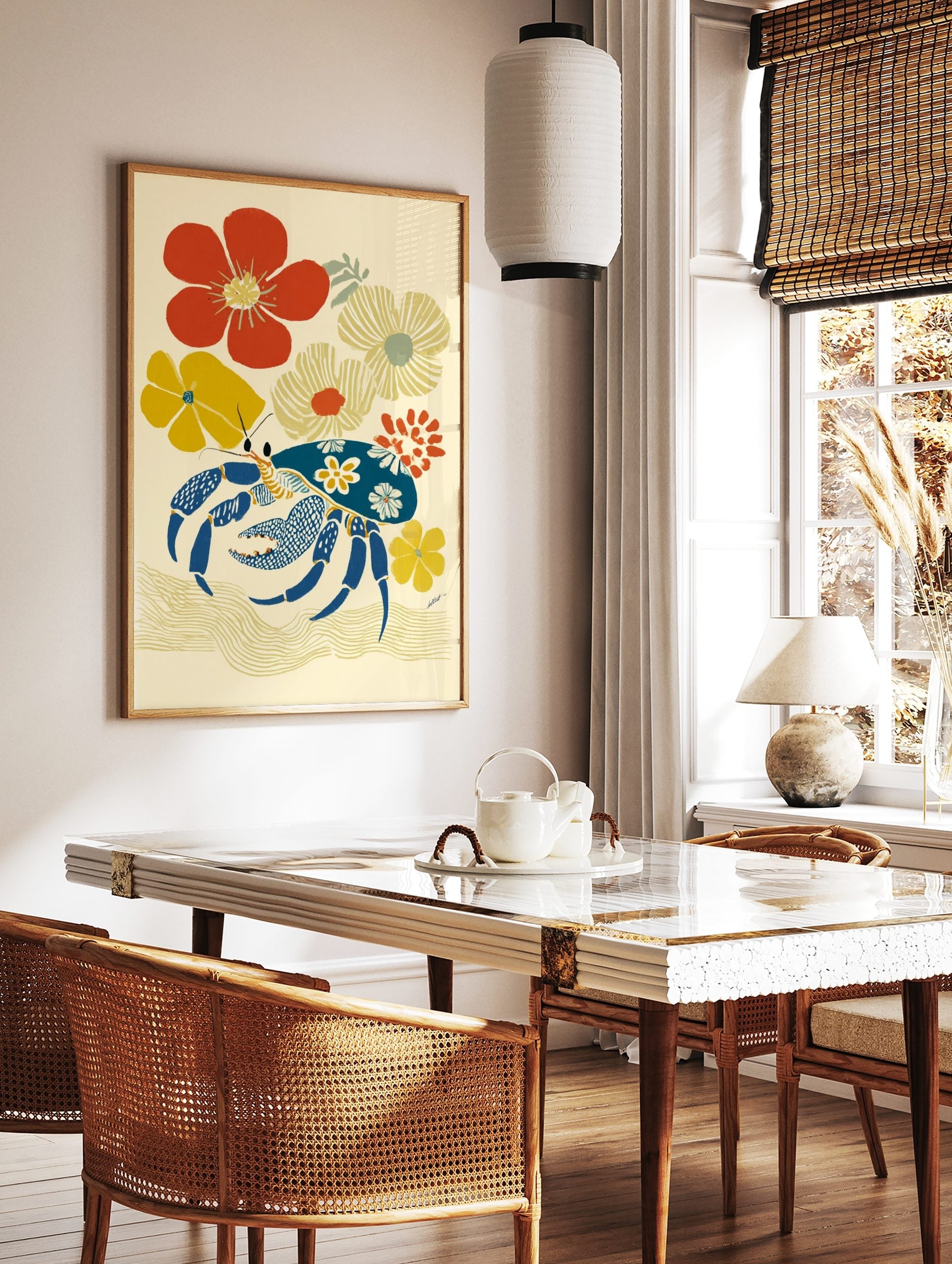 Illustrative art print of a blue crab with floral patterns, surrounded by red and yellow flowers on, in a styled room mockup