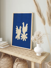 Minimalist art print of two cream doves on a deep blue background with a textured, cut-out, in an alternate framed mockup