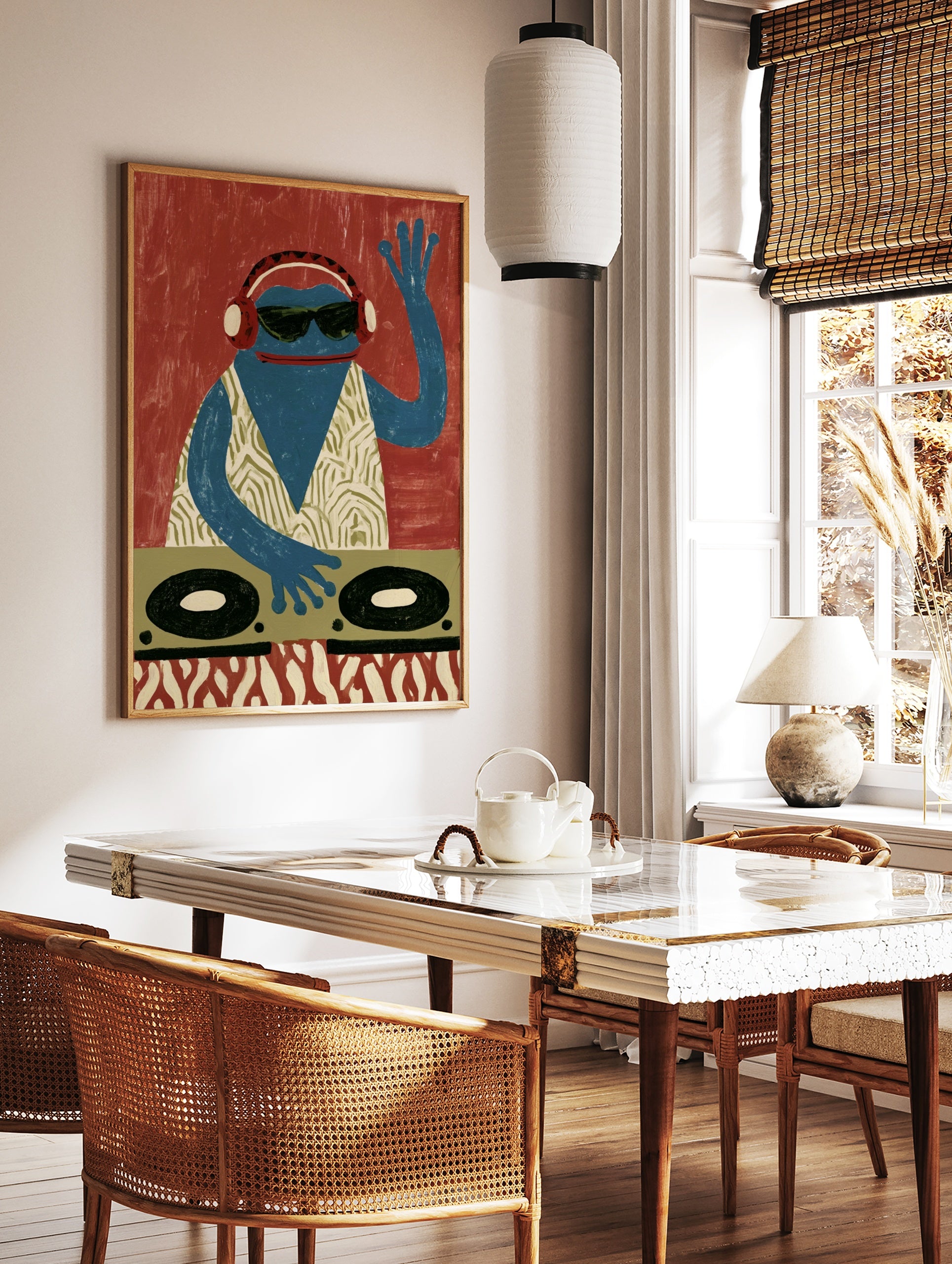 A blue frog DJ wearing headphones and sunglasses behind turntables, graphic illustrative wall art, in a styled room mockup