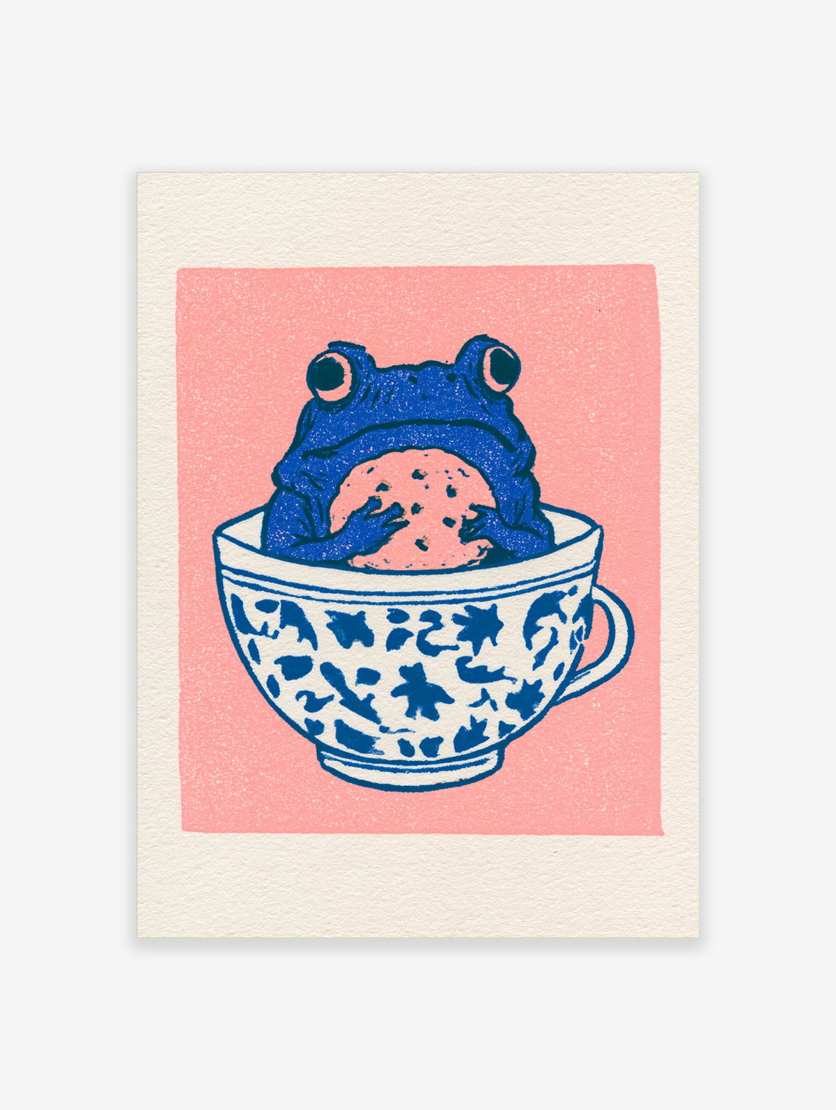 Illustrative blue frog sitting in a patterned teacup holding a cookie against a solid pink background art print