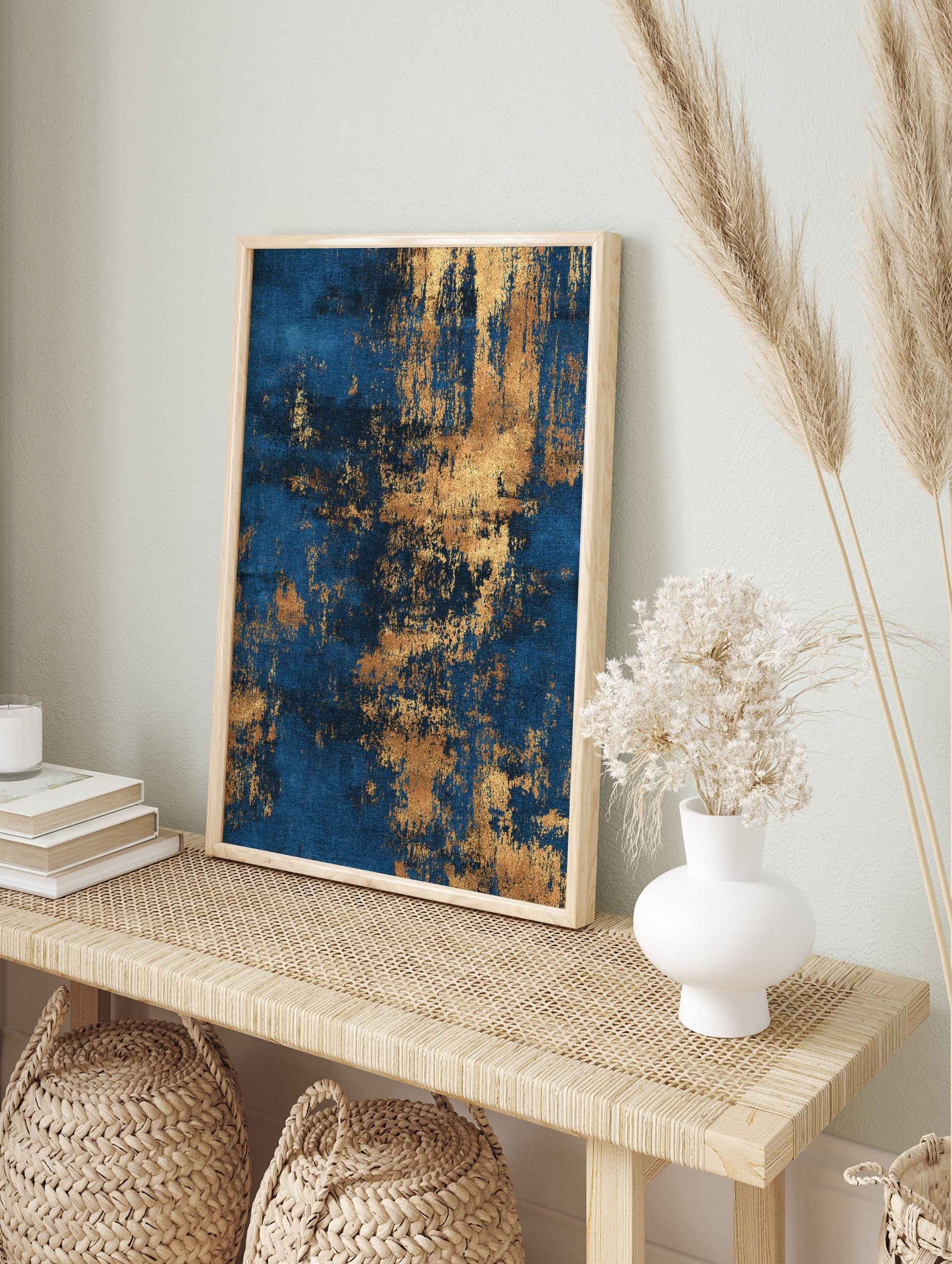 Abstract wall art print with deep blue background and distressed metallic gold textures, in an alternate framed mockup