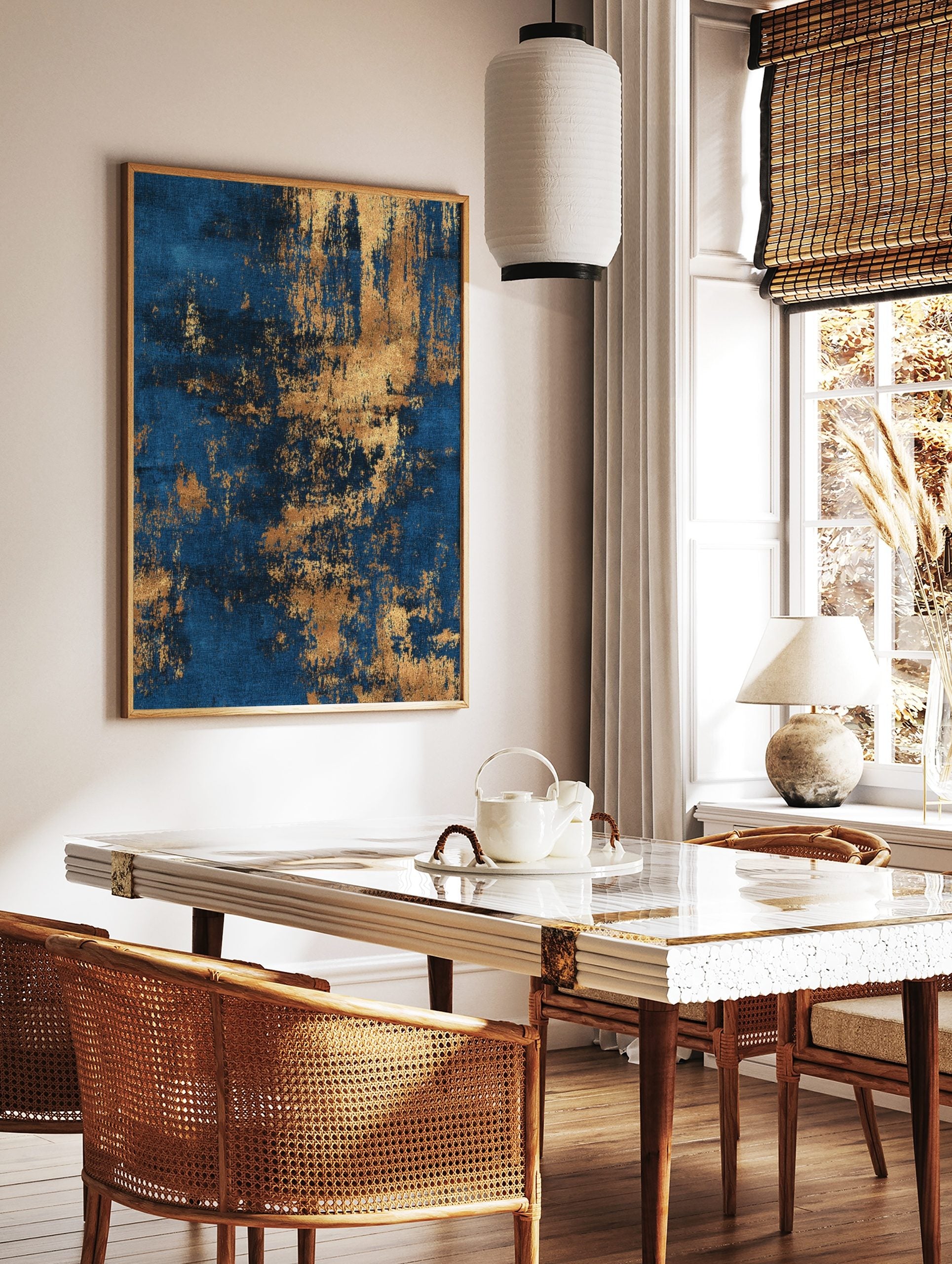 Abstract wall art print with deep blue background and distressed metallic gold textures, in a styled room mockup