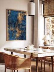 Abstract art print with distressed gold texture over a deep blue background, vertical orientation, in a styled room mockup