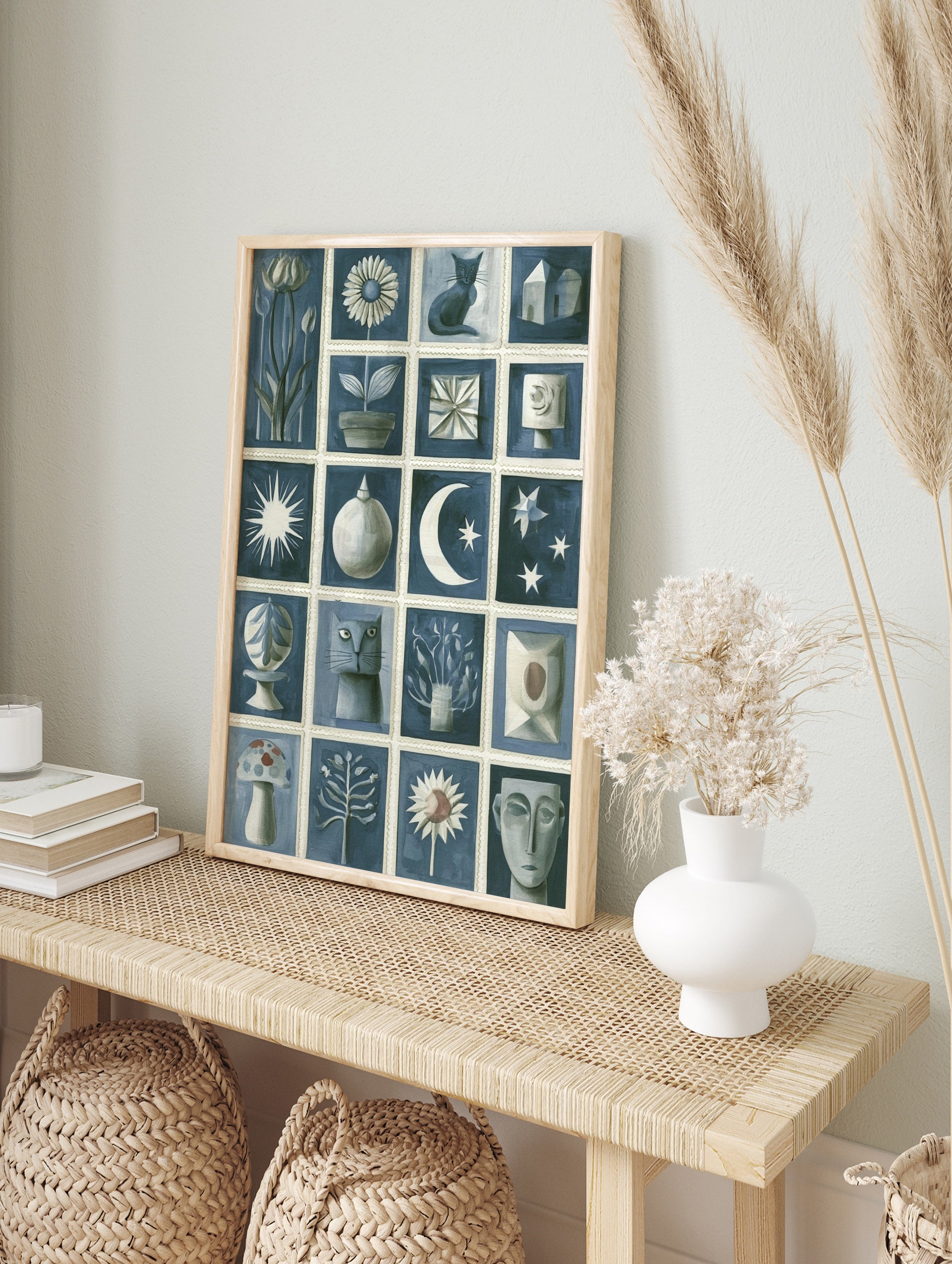 Blue and white illustrative grid art print featuring cats, flowers, moon, stars, and abstract, in an alternate framed mockup