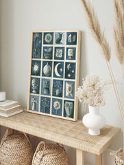 Blue and white illustrative grid art print featuring cats, flowers, moon, stars, and abstract, in an alternate framed mockup
