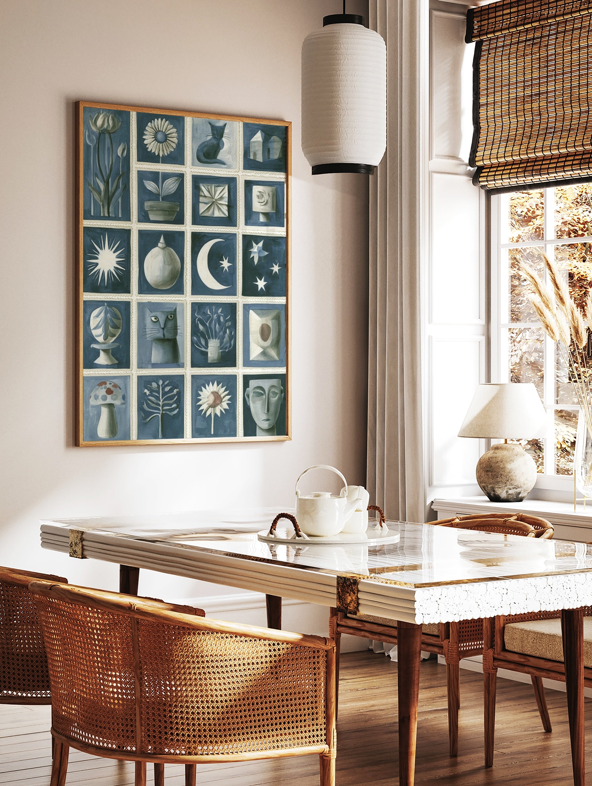 Blue and white illustrative grid art print featuring cats, flowers, moon, stars, and abstract shapes, in a styled room mockup