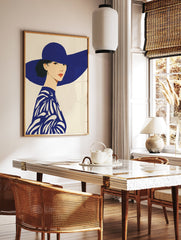 Illustrative art print of a woman in a wide-brimmed blue hat and patterned blue top against a cream background. Blue Hat Woman Wall Art. - Image 2