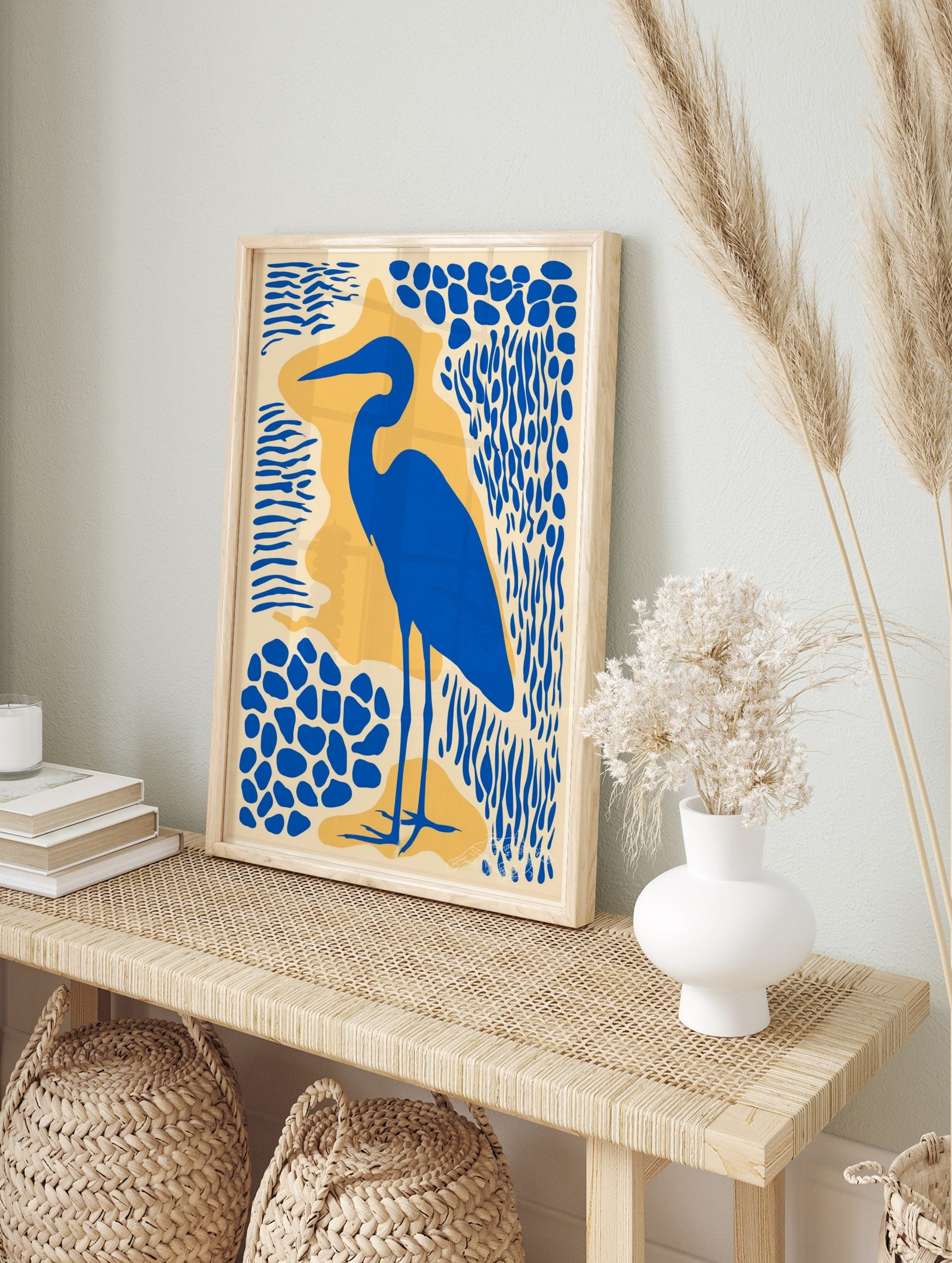 Blue heron bird silhouette art print with abstract blue and yellow shapes on a cream, in an alternate framed mockup