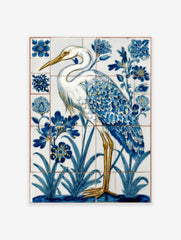 White heron with blue and gold feathers standing in water with blue flowers, in a tile-style art print