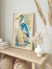 Blue heron bird illustration wall art in watercolour and ink with a yellow beak and pink legs, in an alternate framed mockup
