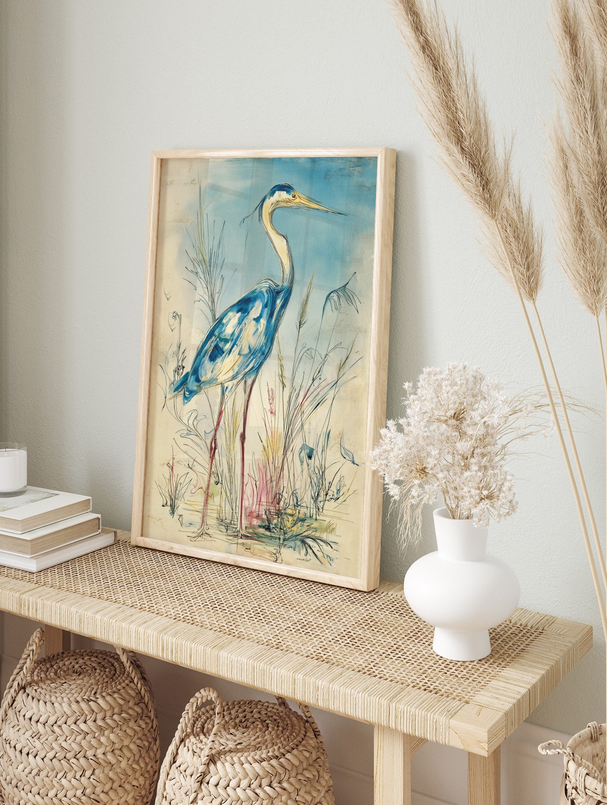 Blue heron bird wall art illustration in watercolour style, standing amidst reeds with a, in an alternate framed mockup