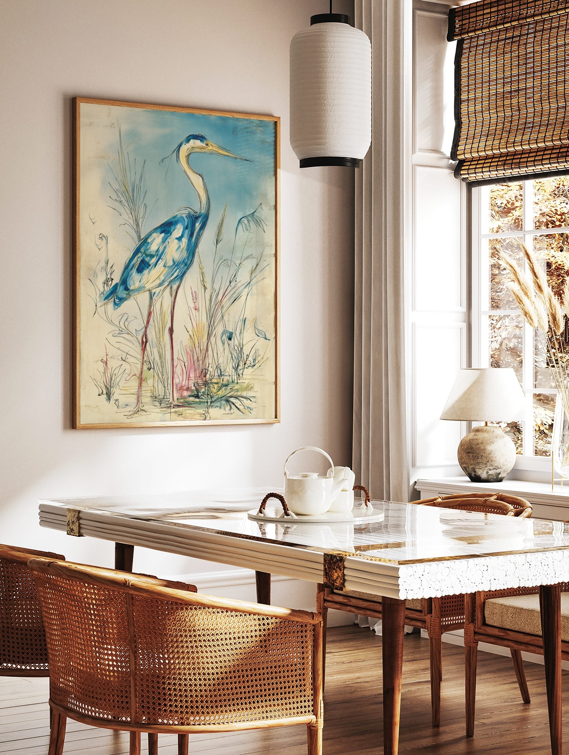 Blue heron bird wall art illustration in watercolour style, standing amidst reeds with a light blue, in a styled room mockup