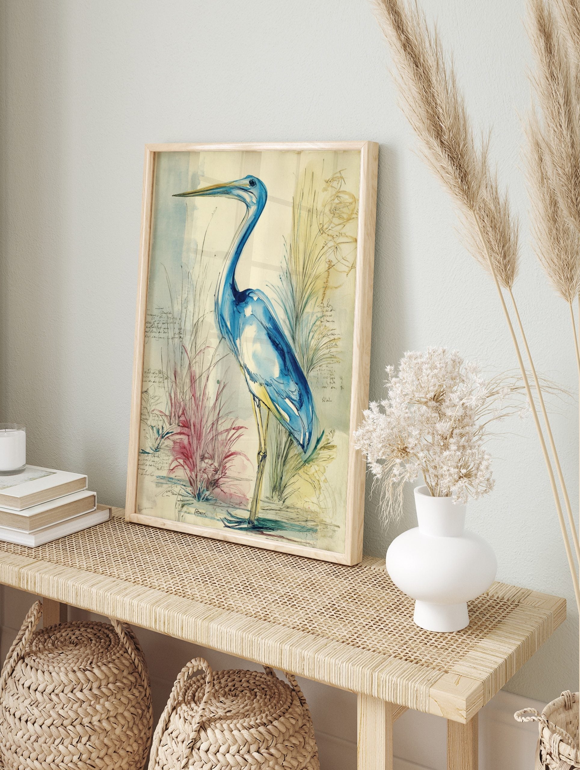 Blue heron watercolour illustration with blue washes, ink lines, and faint handwritten notes, in an alternate framed mockup