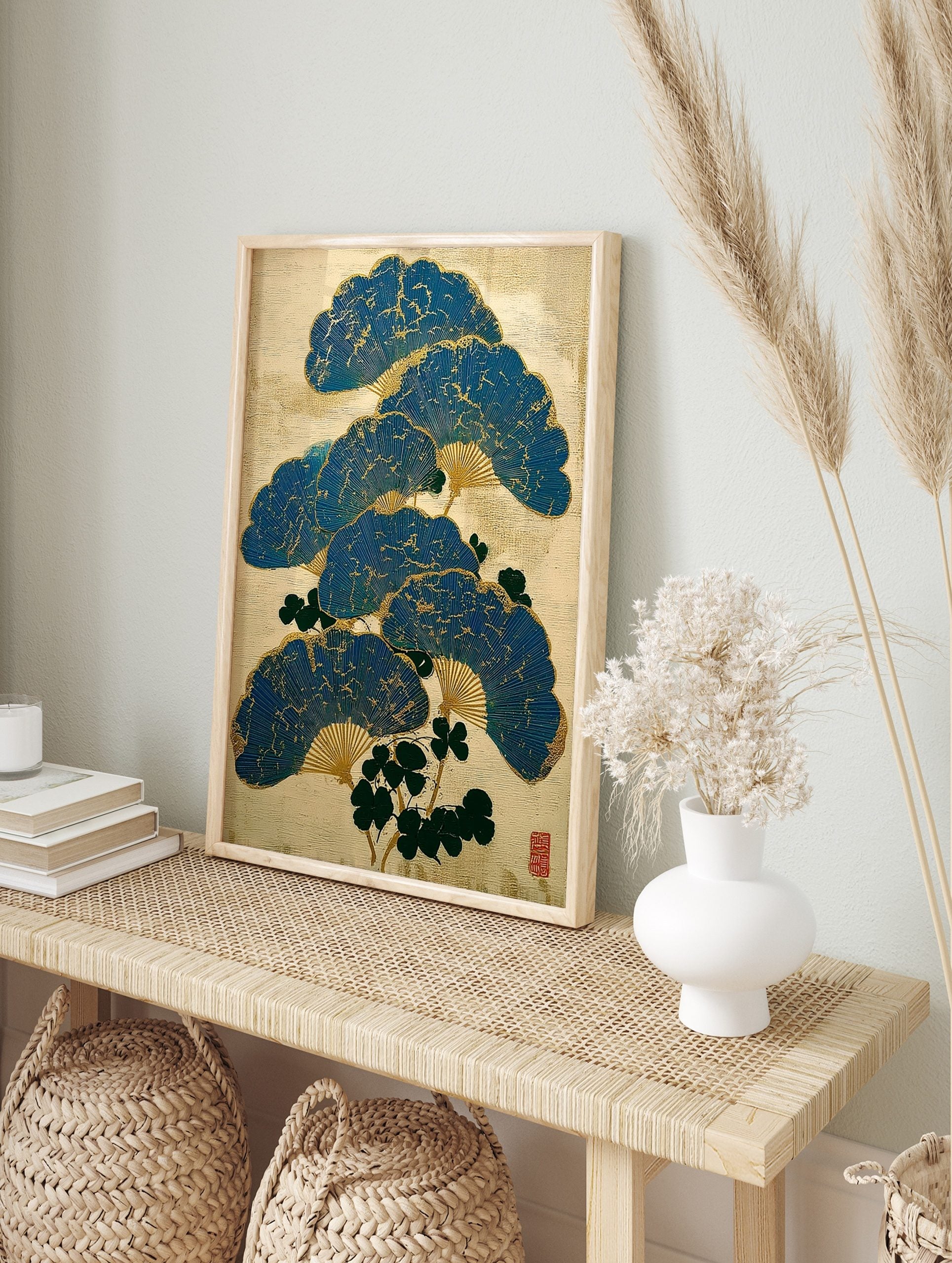 Blue Japanese folding fans with gold cracked texture and green leaves on a beige background, in an alternate framed mockup