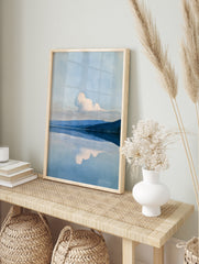 Minimalist landscape wall art featuring a mountain range reflected in a calm blue lake with a, in an alternate framed mockup