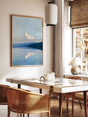 Minimalist landscape wall art featuring a mountain range reflected in a calm blue lake with a, in a styled room mockup