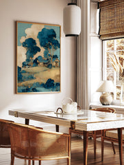 Illustrative blue and beige landscape art print with a house on a hill, surrounded by stylised, in a styled room mockup