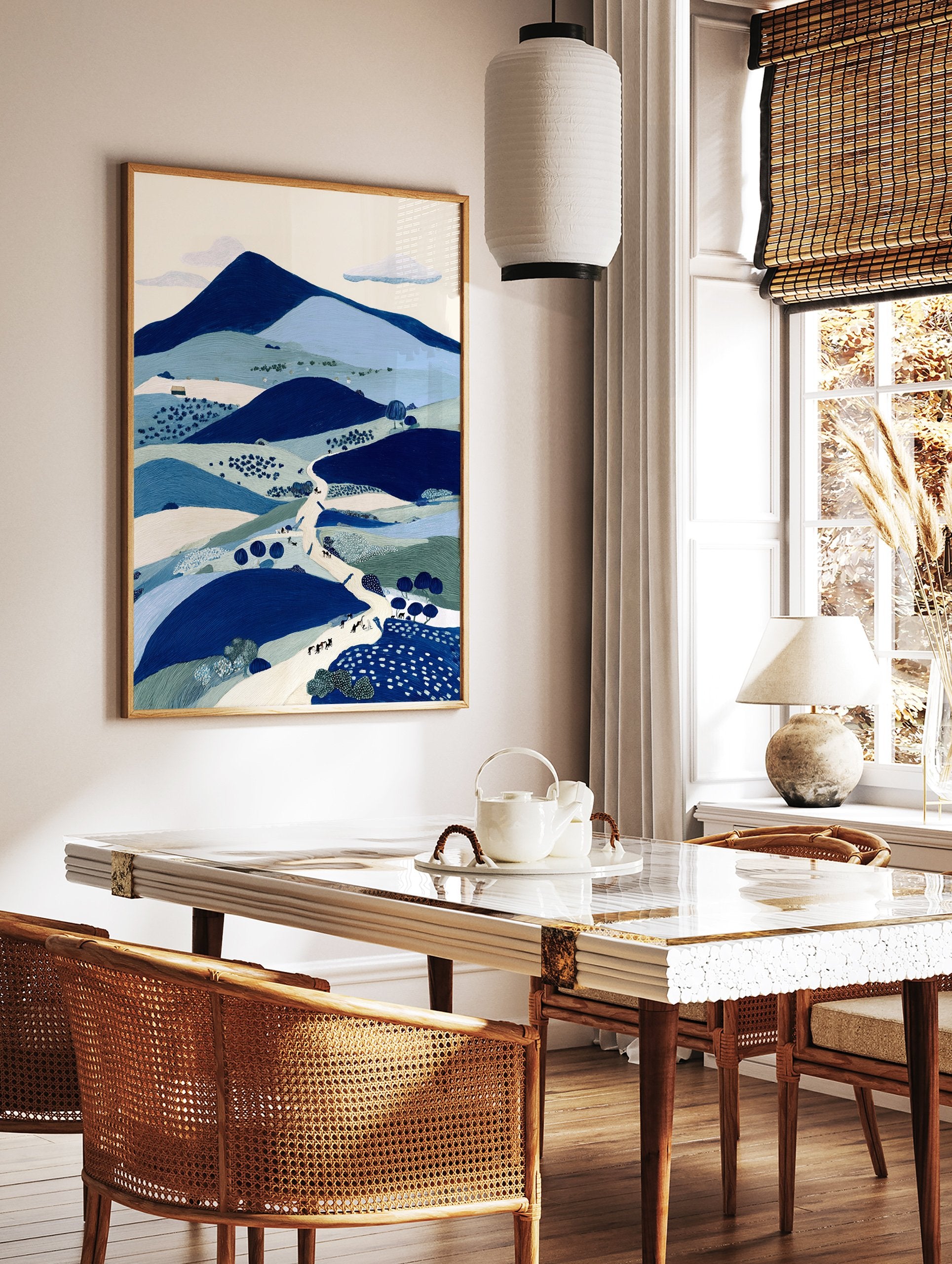Illustrative blue landscape wall art print featuring mountains, hills, a winding path with figures, and trees. - Image 2
