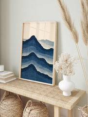 Japanese style mountain landscape art print with layered blue peaks on a cream background, in an alternate framed mockup