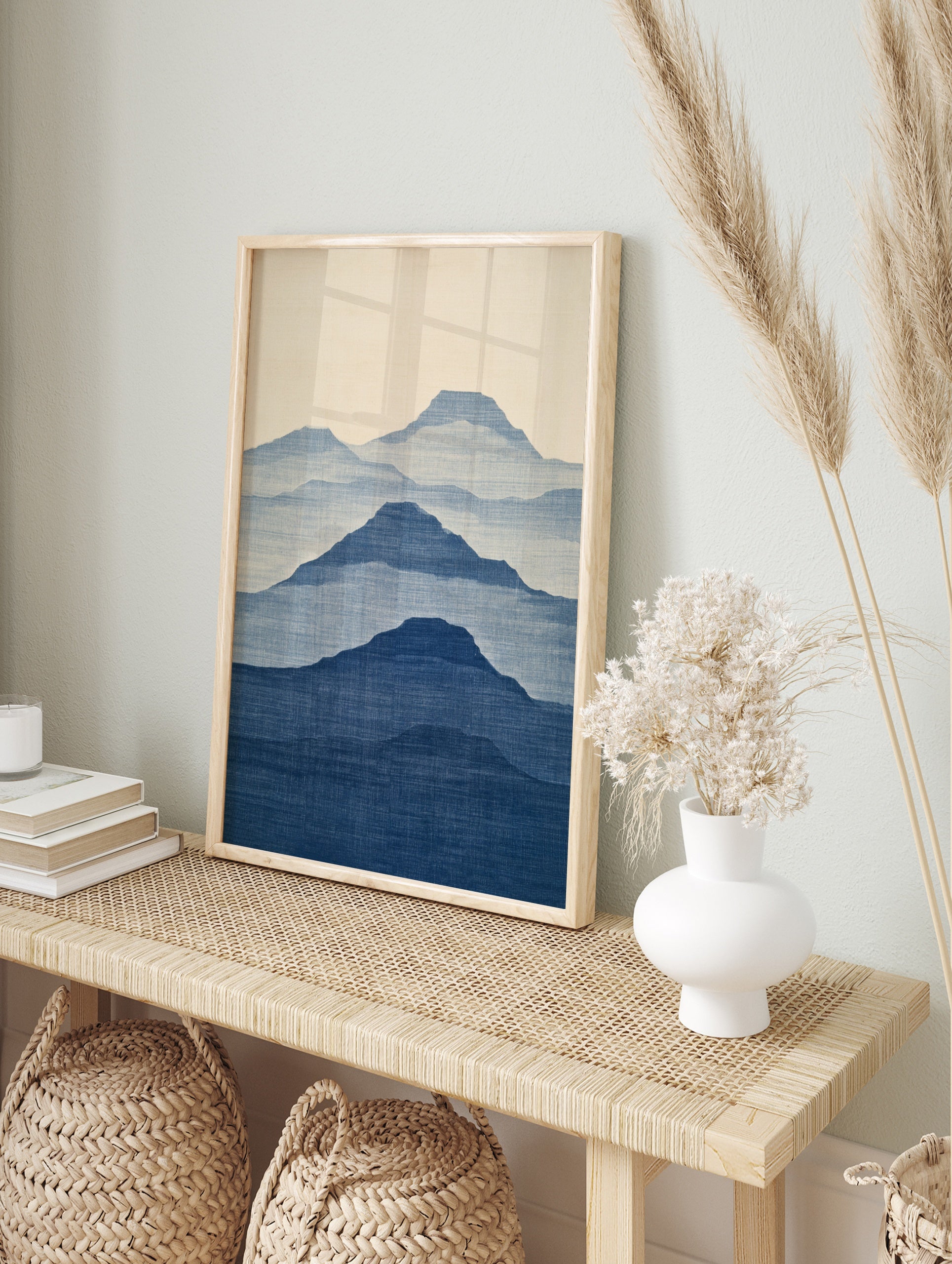Minimalist mountain landscape wall art with layered blue silhouettes and fabric texture on a, in an alternate framed mockup