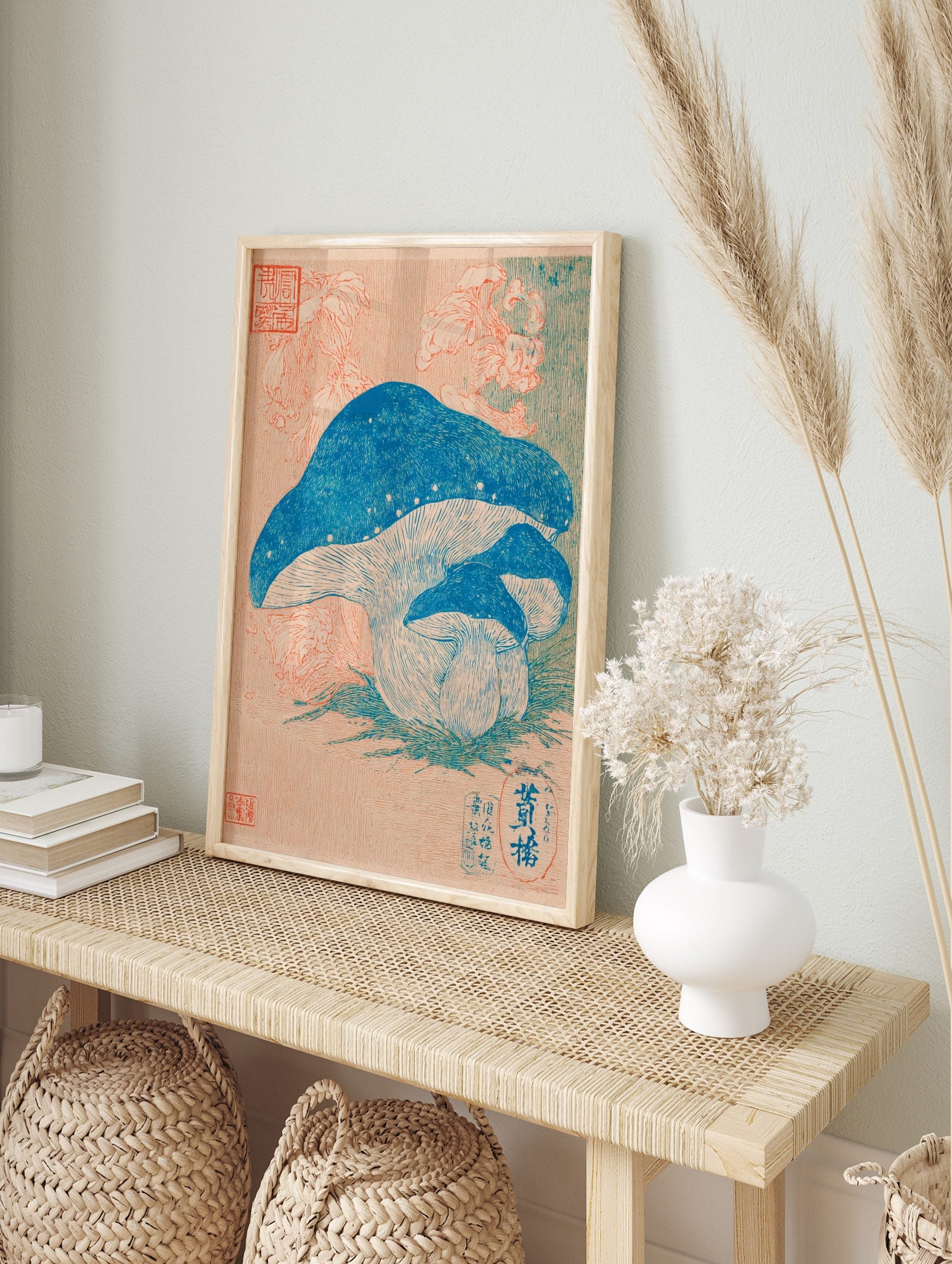 Japanese botanical print of three blue mushrooms with pale gills on green grass, peach, in an alternate framed mockup