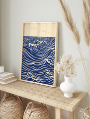 Stylised blue ocean waves with white crests and horizon line on an unframed paper print, in an alternate framed mockup