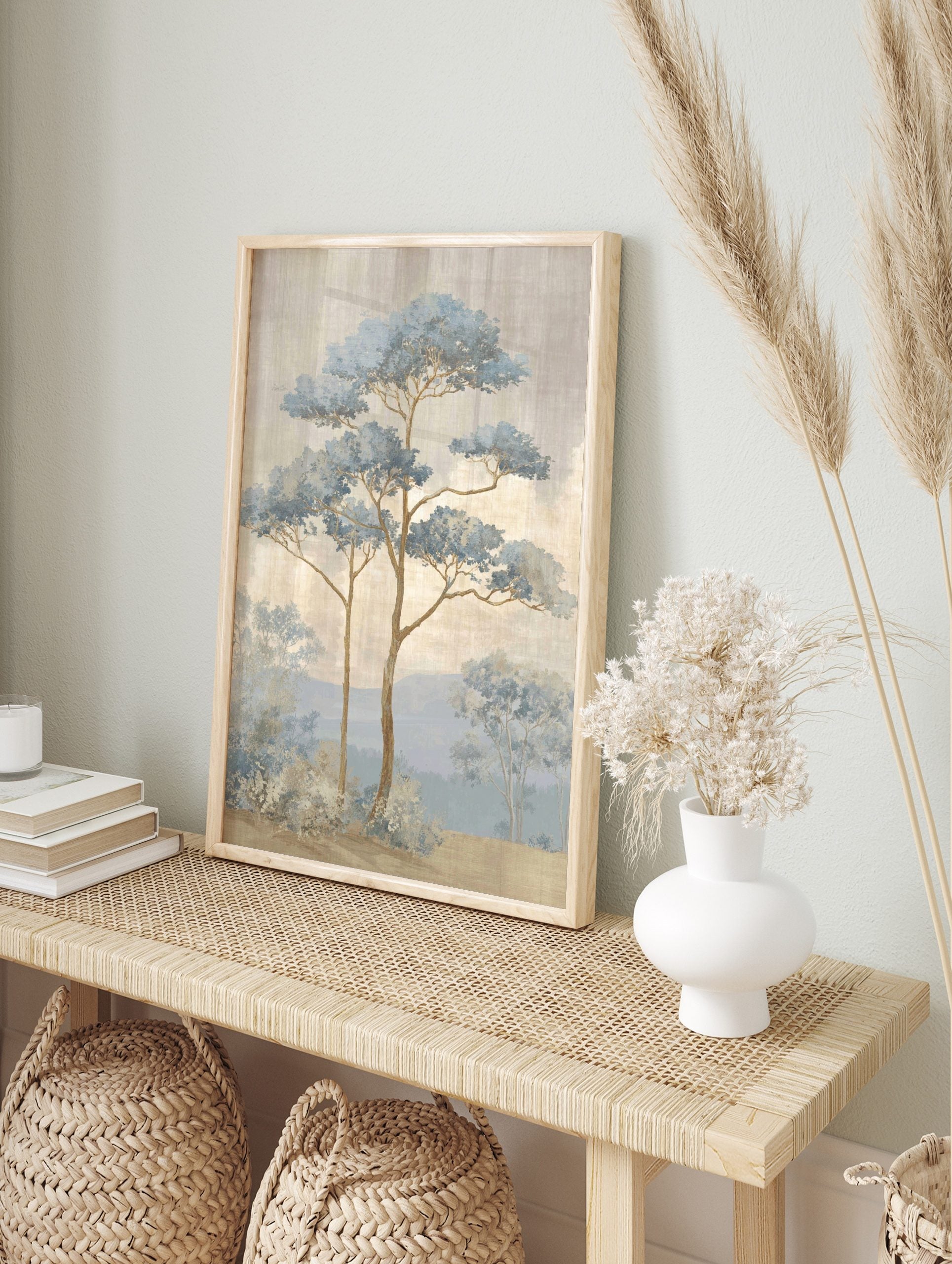 Illustrative blue pine trees in a misty landscape with mountains and textured sky, in an alternate framed mockup