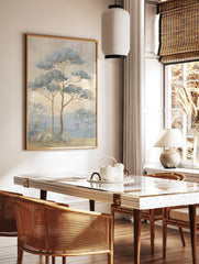 Illustrative blue pine trees in a misty landscape with mountains and textured sky, in a styled room mockup