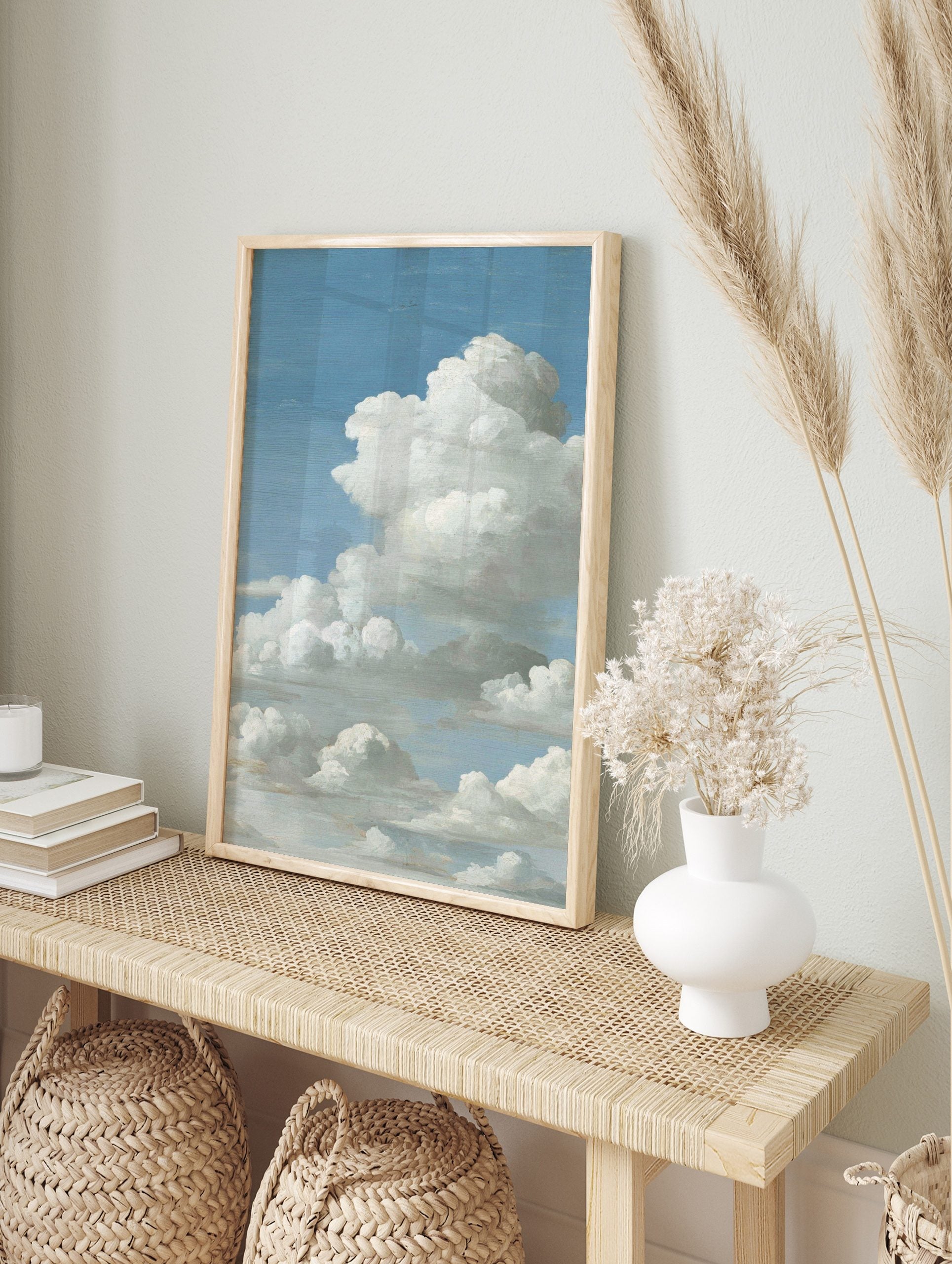 Close-up of fluffy white cumulus clouds against a bright blue sky, filling the vertical frame, in an alternate framed mockup