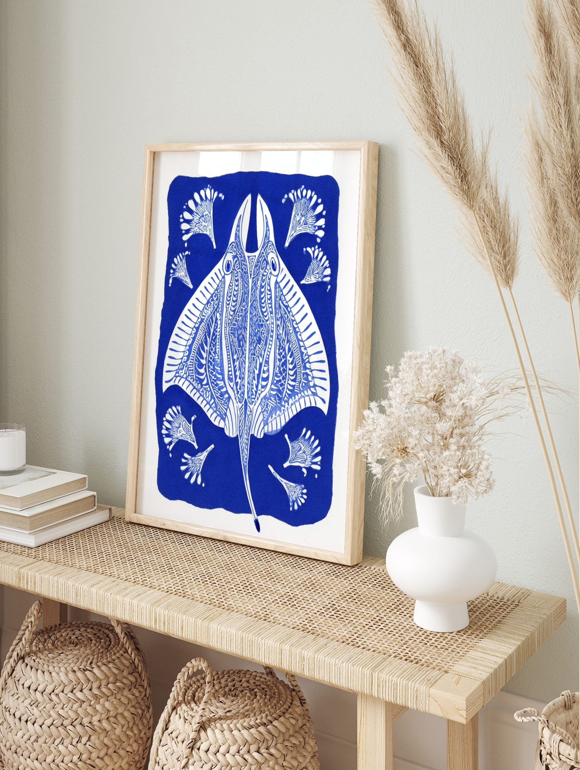 Ornate blue and white stingray illustration with decorative fan-like elements on a deep blue, in an alternate framed mockup