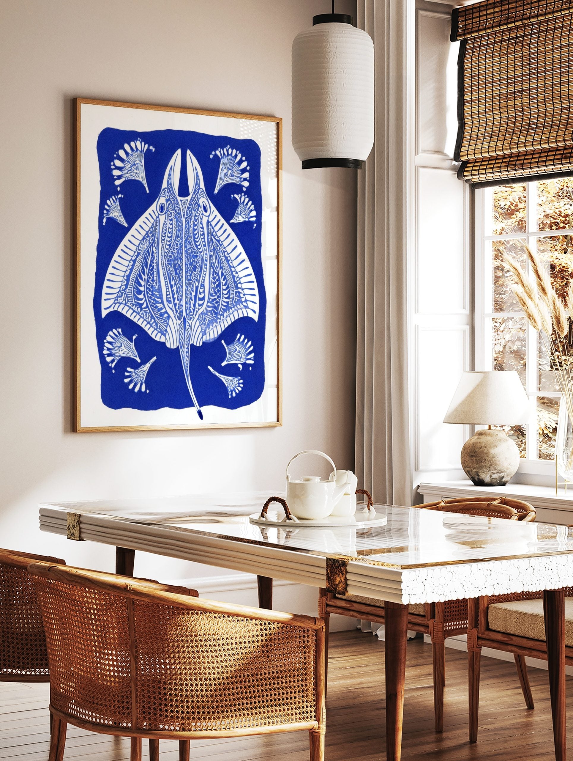 Ornate blue and white stingray illustration with decorative fan-like elements on a deep blue, in a styled room mockup