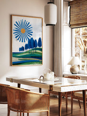 Abstract landscape art print with blue sun, blue trees on green hills, and layered fields, in a styled room mockup