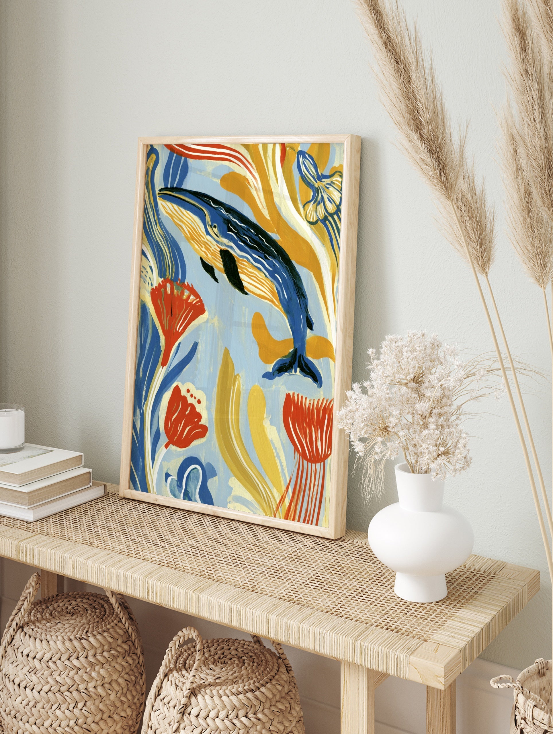 Blue whale swimming among stylized yellow and orange seaweed, modern illustrative ocean art, in an alternate framed mockup