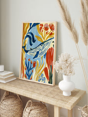 Blue whale illustration with golden seaweed and red flowers, painterly underwater wall art, in an alternate framed mockup