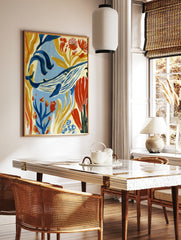 Blue whale illustration with golden seaweed and red flowers, painterly underwater wall art print, in a styled room mockup
