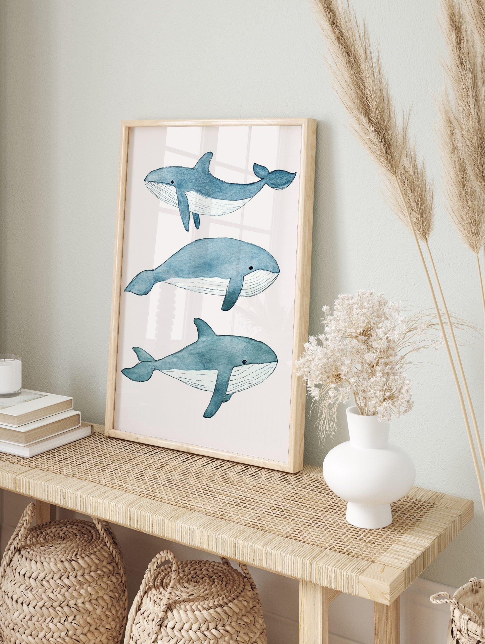 Three illustrative blue whales in watercolour style on a white background, arranged vertically, in an alternate framed mockup